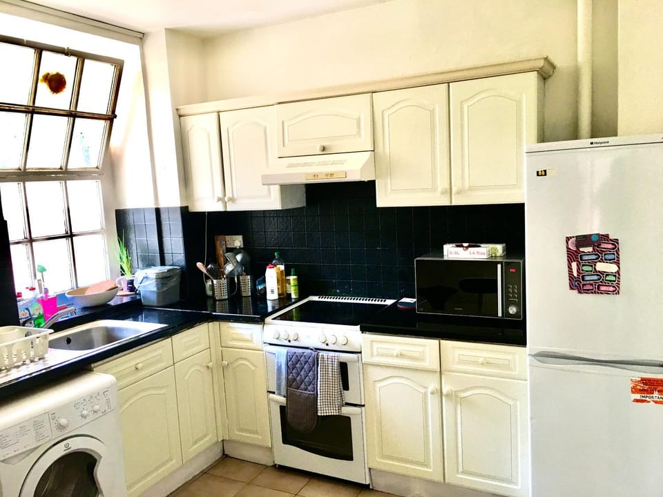 Kitchen or kitchenette, microwave, oven, stove, washing machine