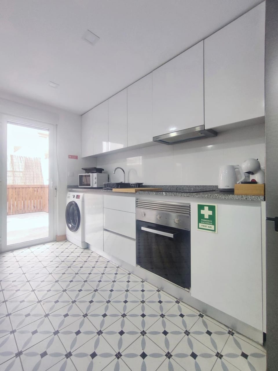 Kitchen or kitchenette, microwave, stove, washing machine