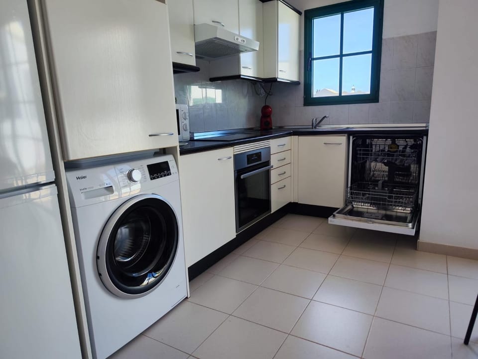 Kitchen or kitchenette, dishwasher, oven, stove, washing machine