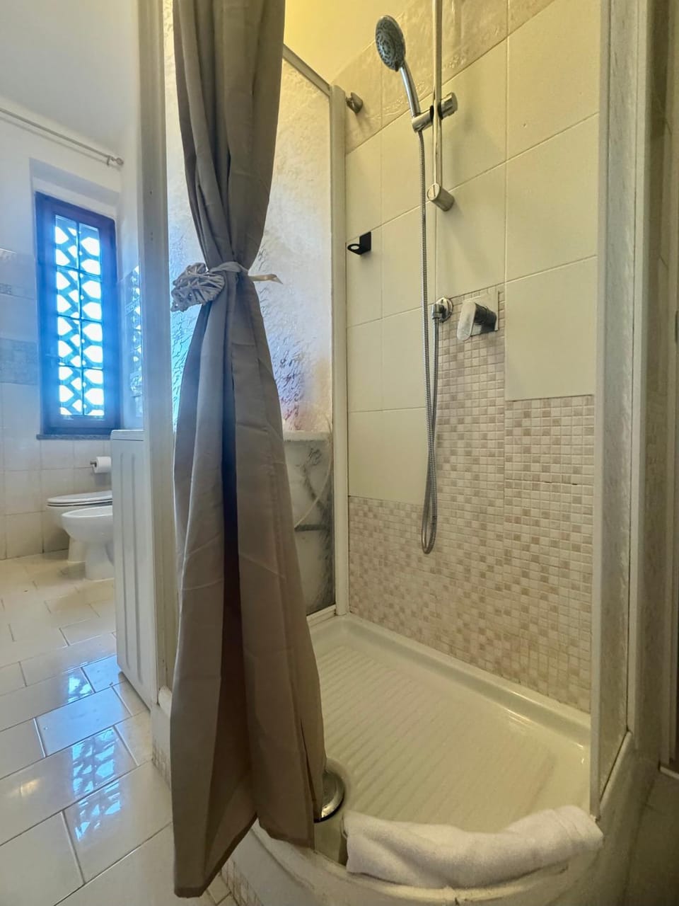 Shower, Toilet, Bathroom, Decorative detail, hair dryier, towels, washing machine