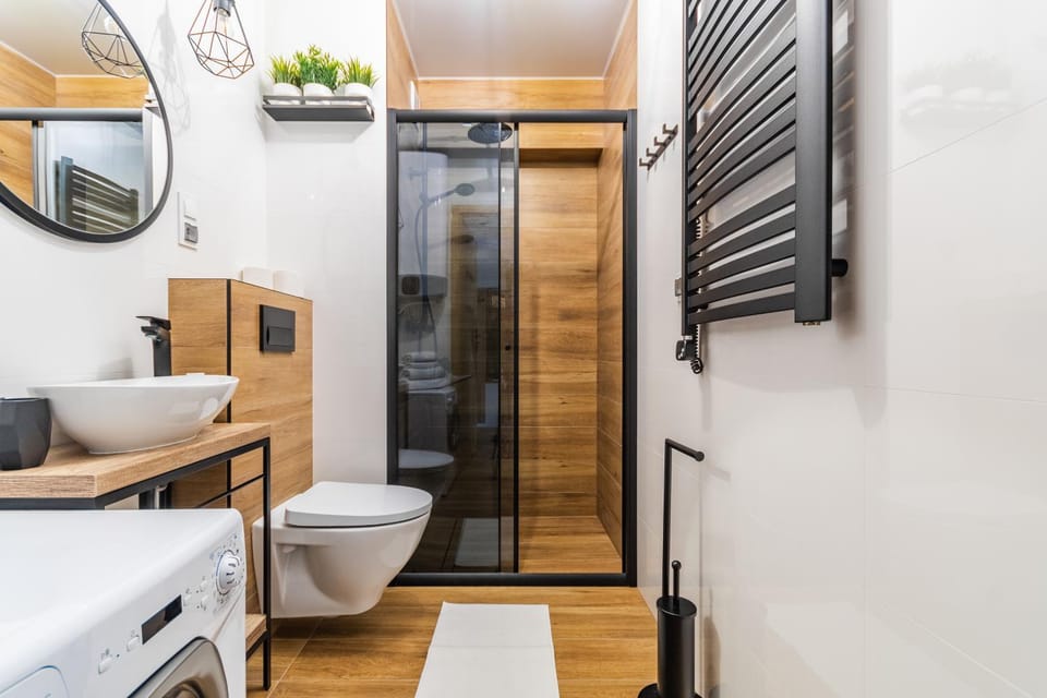 Shower, Toilet, Bathroom, hair dryier, towels, washing machine