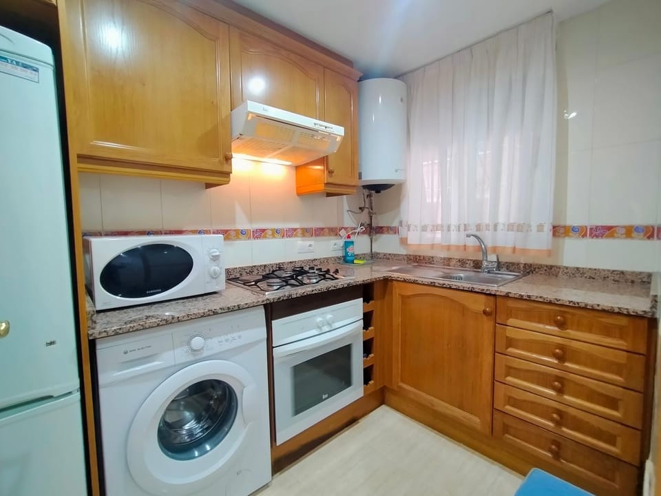 Kitchen or kitchenette, microwave, oven, stove, washing machine