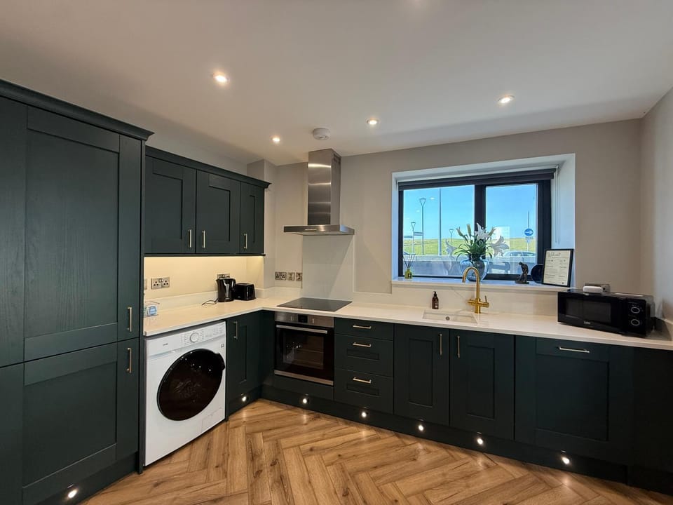 Kitchen or kitchenette, dishwasher, oven, stove, toaster, washing machine, dryer