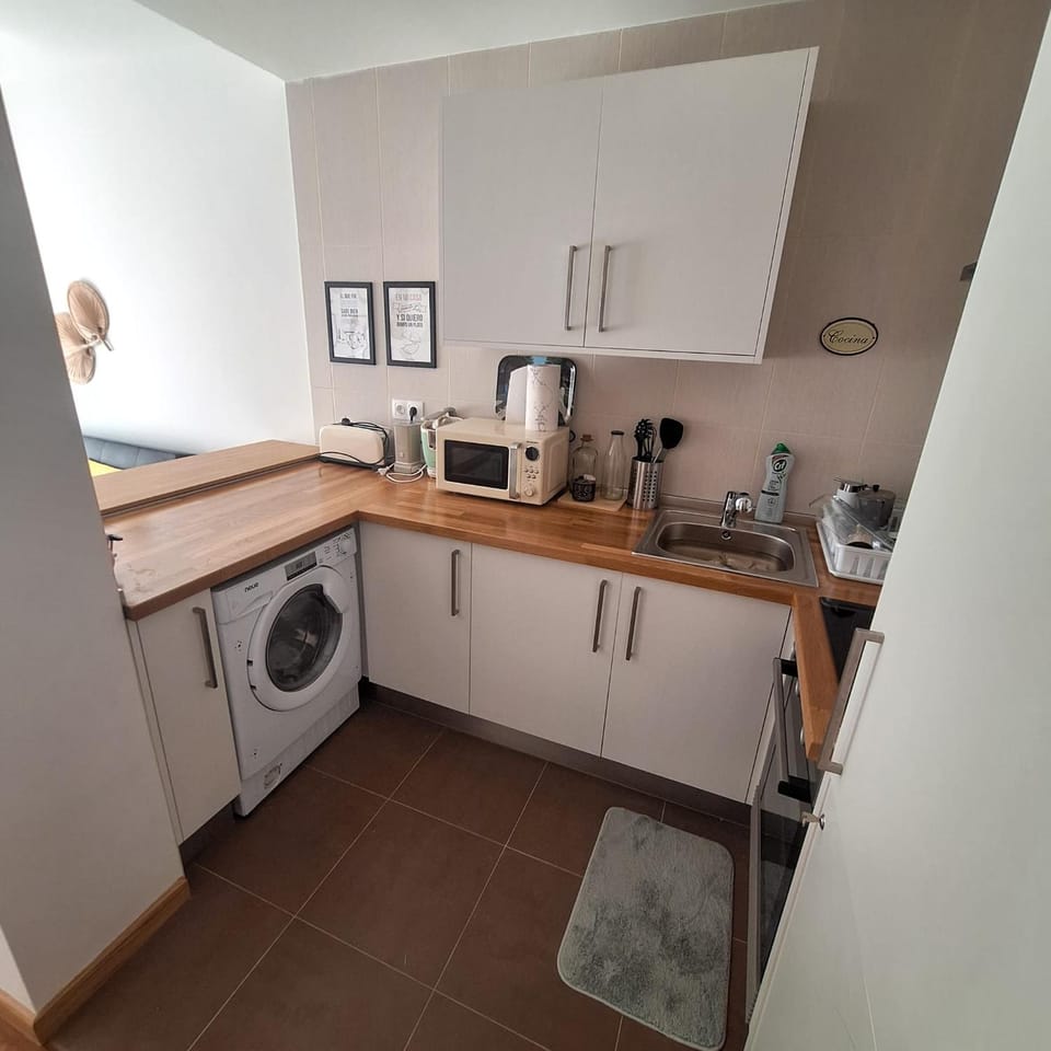 Kitchen or kitchenette, oven, stove, toaster, washing machine