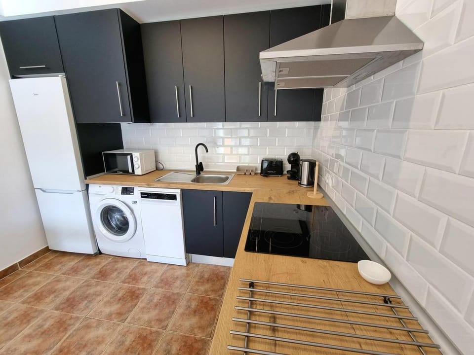 Kitchen or kitchenette, dishwasher, oven, stove, toaster, washing machine