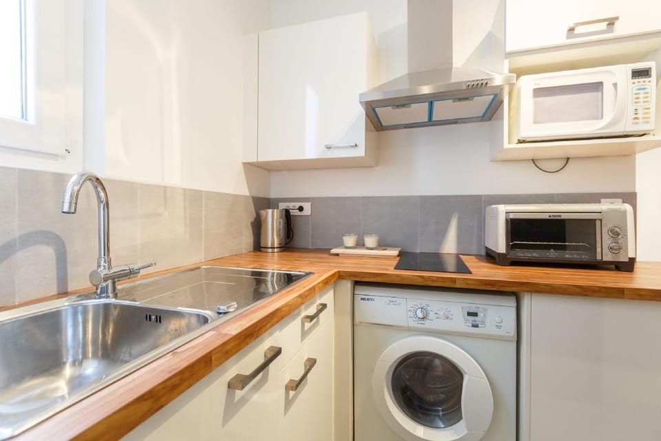 Kitchen or kitchenette, microwave, stove, toaster, washing machine, kitchen