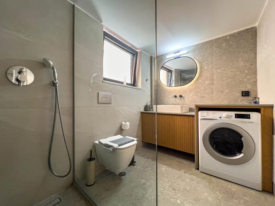 Shower, Toilet, Bathroom, towels, washing machine, dryer