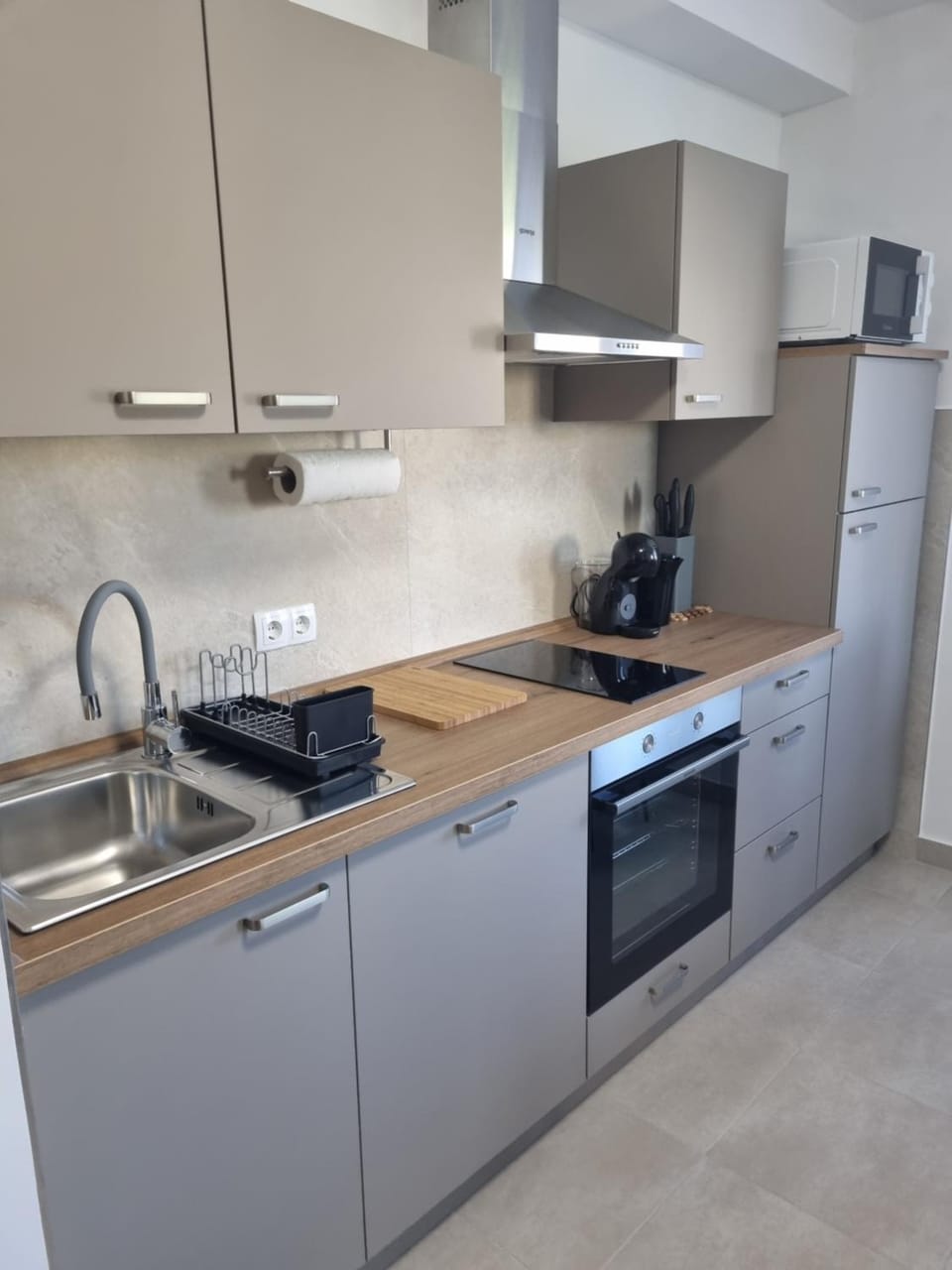 Kitchen or kitchenette, dishwasher, oven, stove