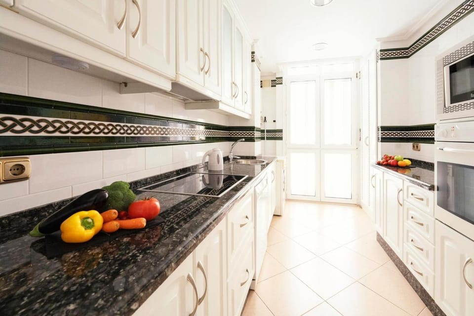 Kitchen or kitchenette, dishwasher, oven, stove