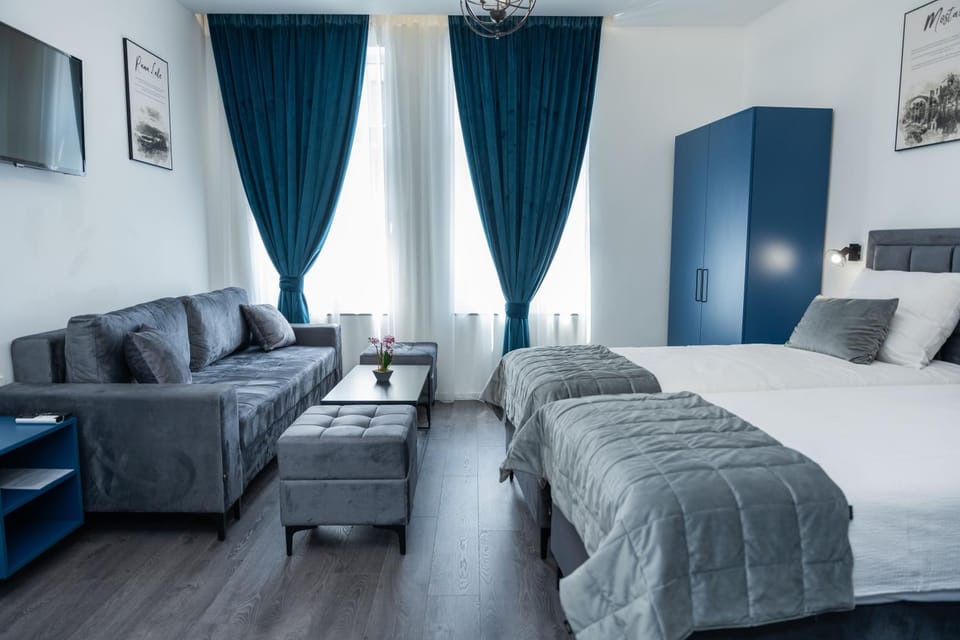 Bed, TV and multimedia, Living room, Seating area, Bedroom