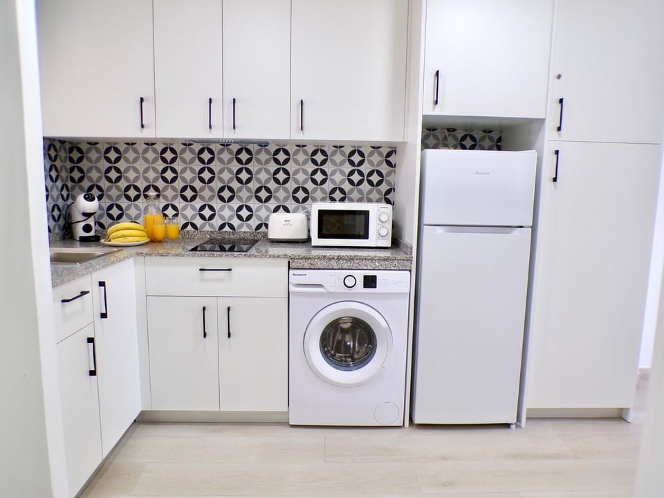 Kitchen or kitchenette, stove, toaster, washing machine