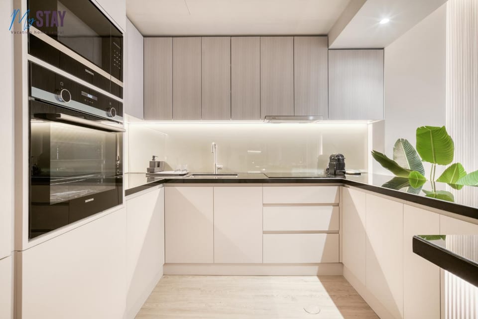 Kitchen or kitchenette, dishwasher, oven, stove