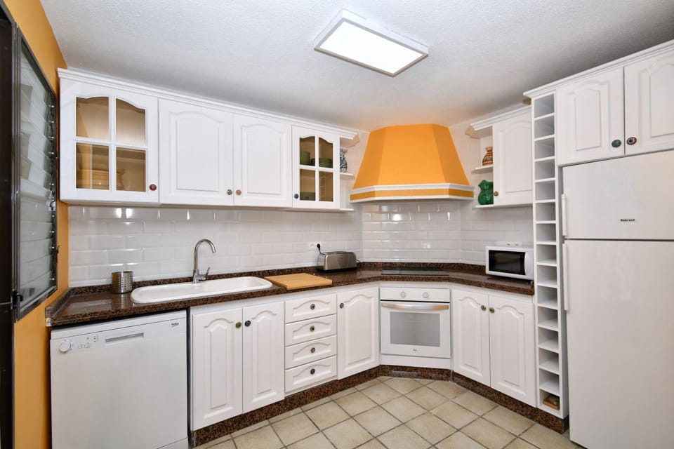 Kitchen or kitchenette, dishwasher, oven, stove