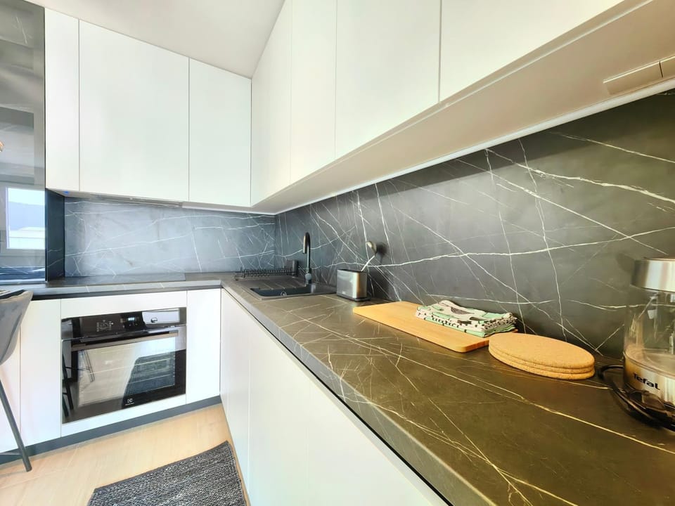 Kitchen or kitchenette, dishwasher, oven, stove
