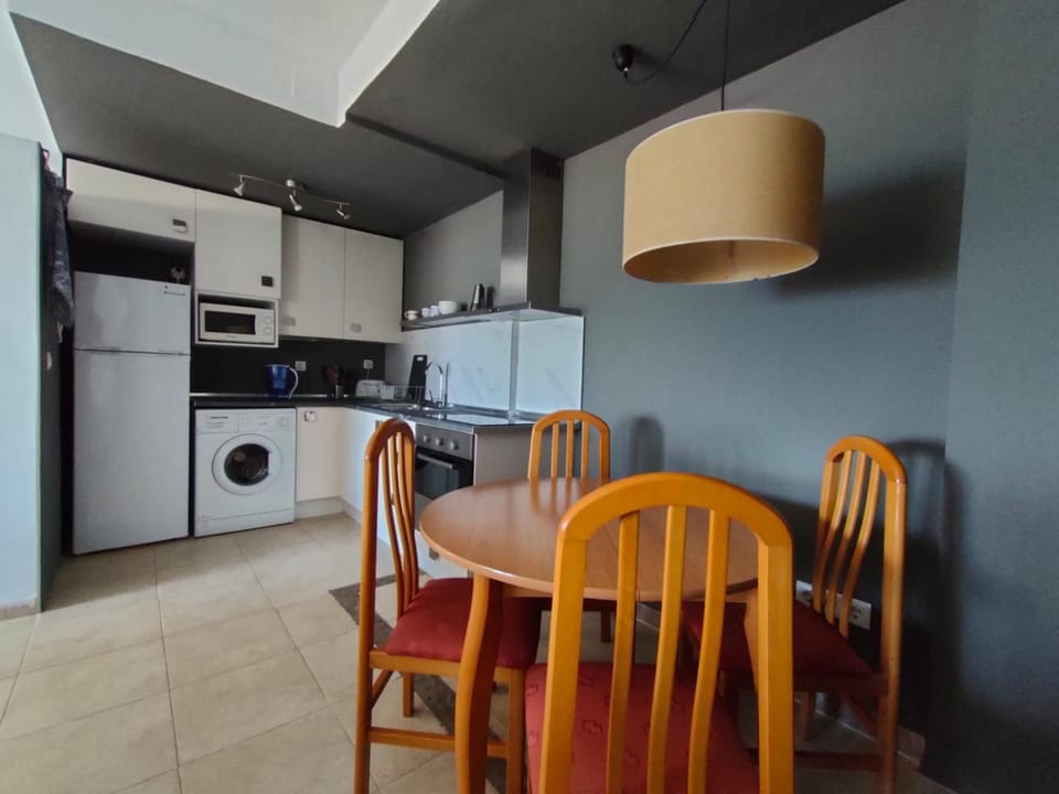 Kitchen or kitchenette, stove, toaster, washing machine