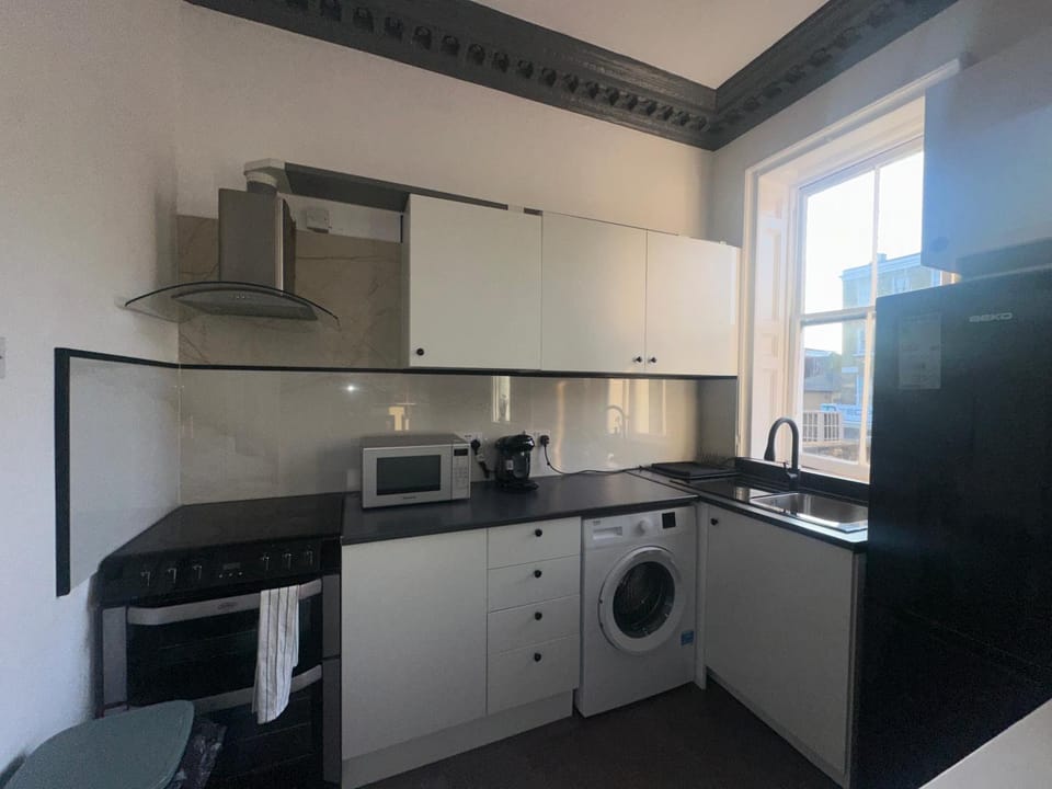 Kitchen or kitchenette, oven, stove, toaster, washing machine