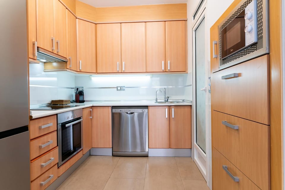 Kitchen or kitchenette, dishwasher, microwave, oven, stove