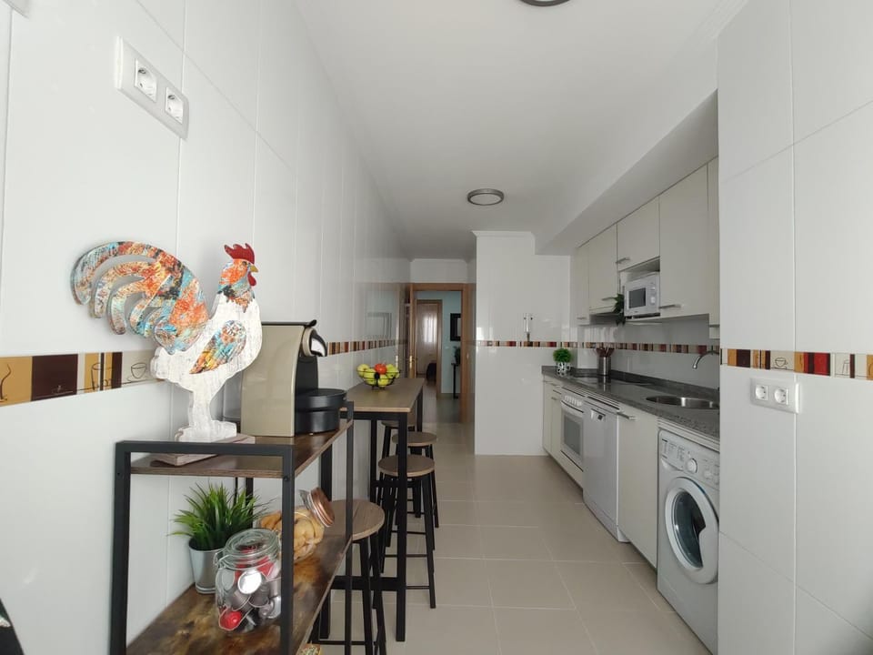 Kitchen or kitchenette, dishwasher, oven, stove, washing machine