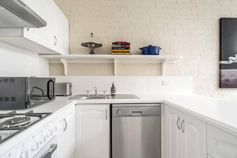 Kitchen or kitchenette, dishwasher, microwave, oven, stove