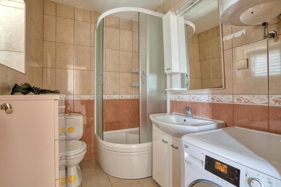 Shower, Toilet, hair dryier, towels, washing machine