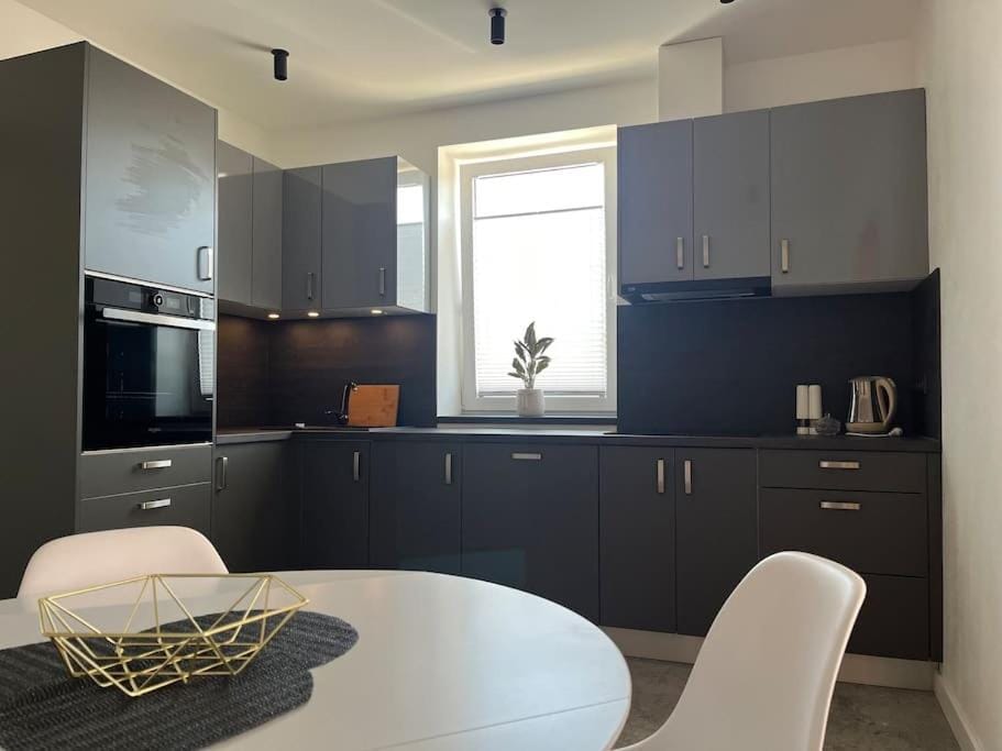Kitchen or kitchenette, dishwasher, oven, stove