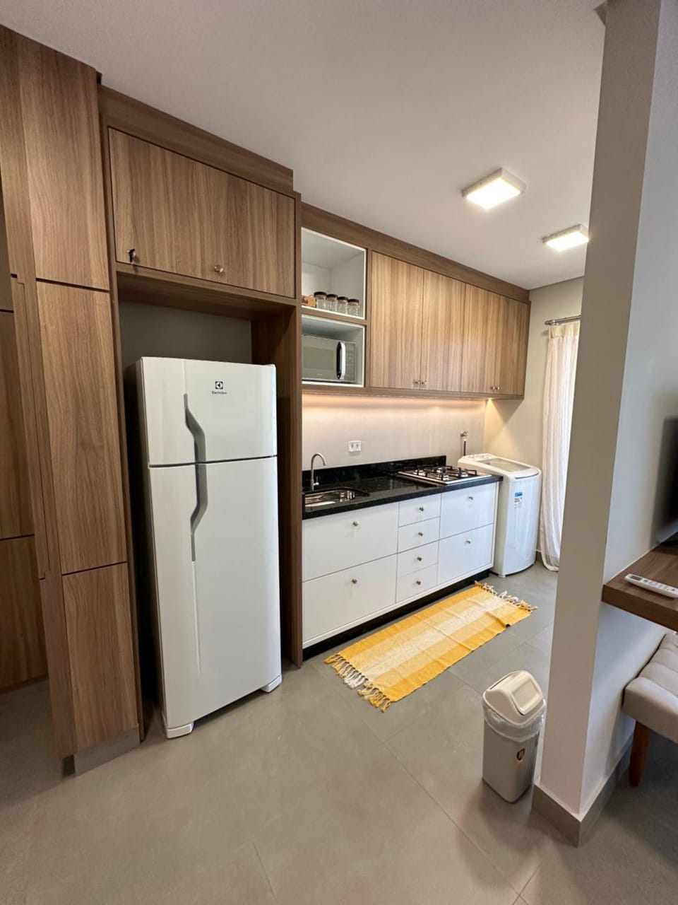 Kitchen or kitchenette, microwave, stove, washing machine