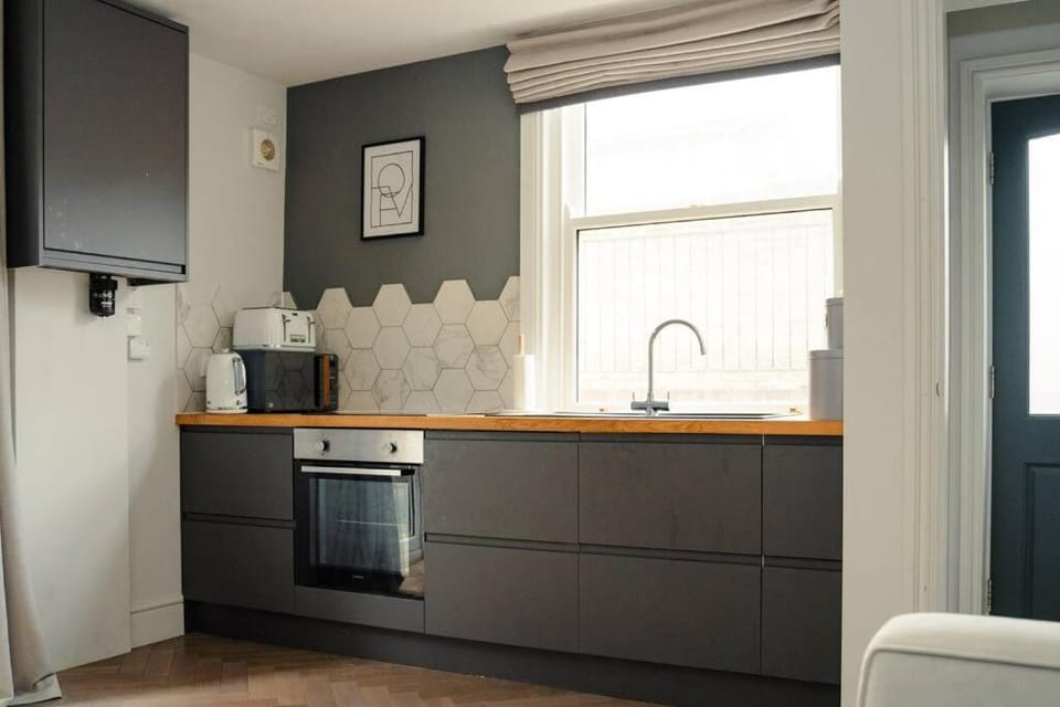 Kitchen or kitchenette, dishwasher, oven, stove