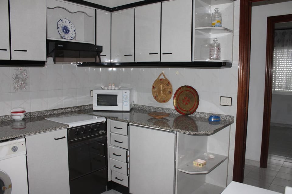 Kitchen or kitchenette, oven, stove, washing machine
