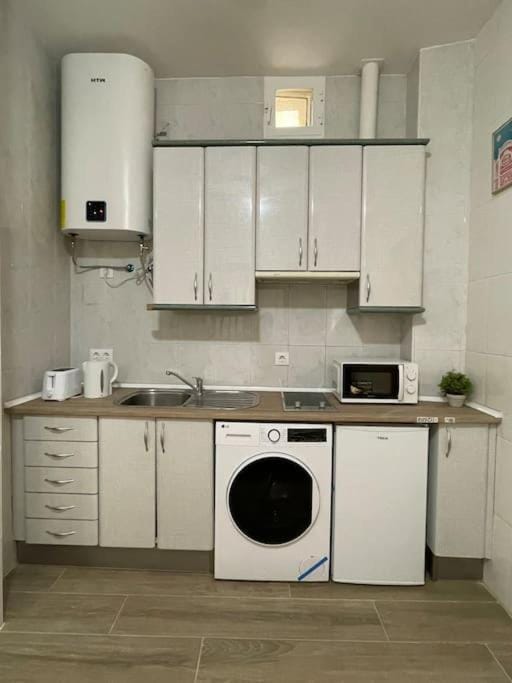 Kitchen or kitchenette, dishwasher, stove, toaster, washing machine