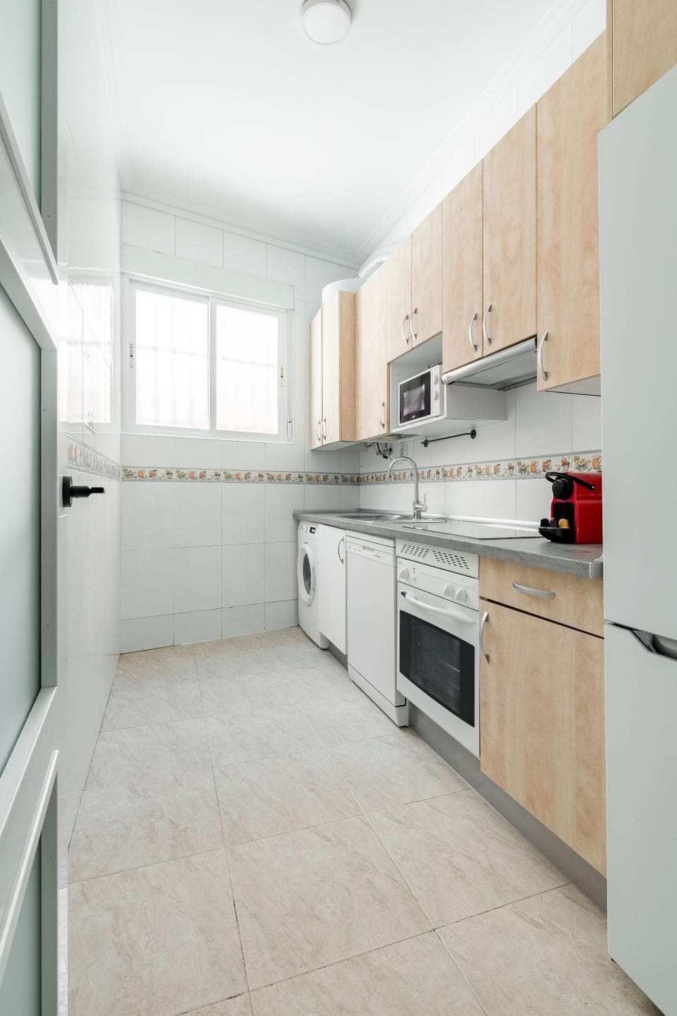Kitchen or kitchenette, dishwasher, oven, stove