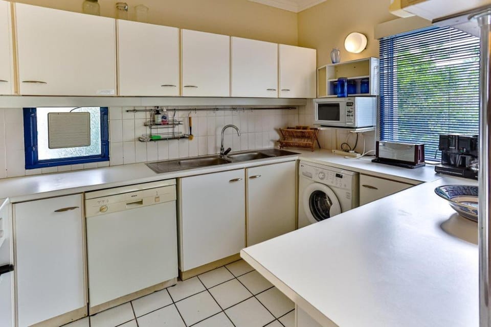 Kitchen or kitchenette, dishwasher, oven, stove, toaster, washing machine