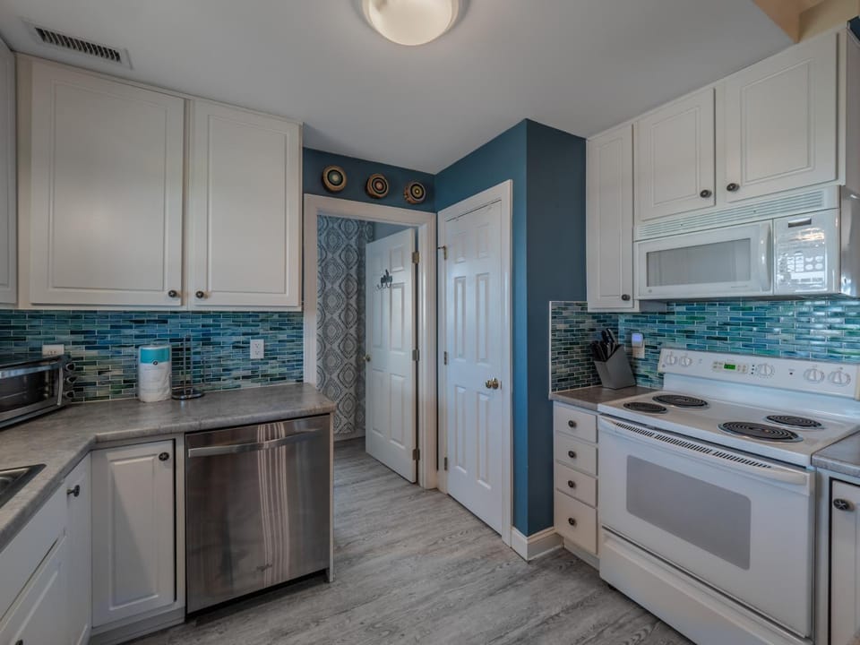 Kitchen or kitchenette, dishwasher, oven, stove