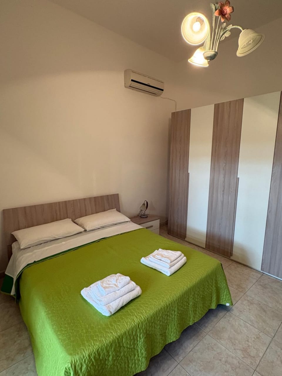 Bed, towels, wardrobe, air conditioner