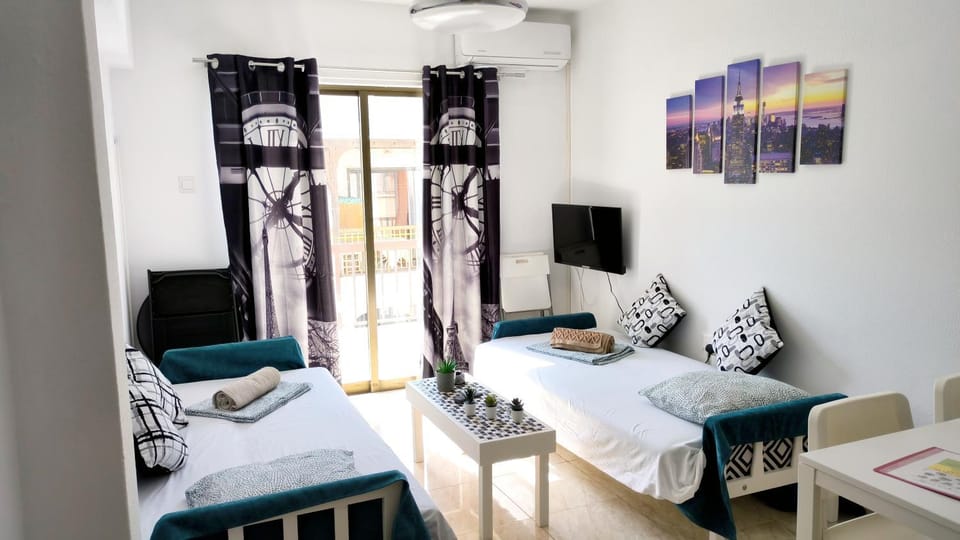 Bed, TV and multimedia, Living room, Seating area, air conditioner