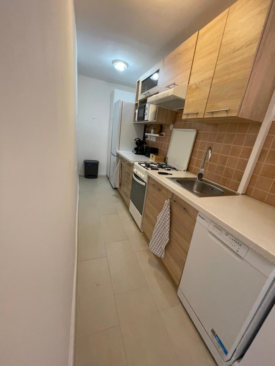 Kitchen or kitchenette, dishwasher, oven, stove