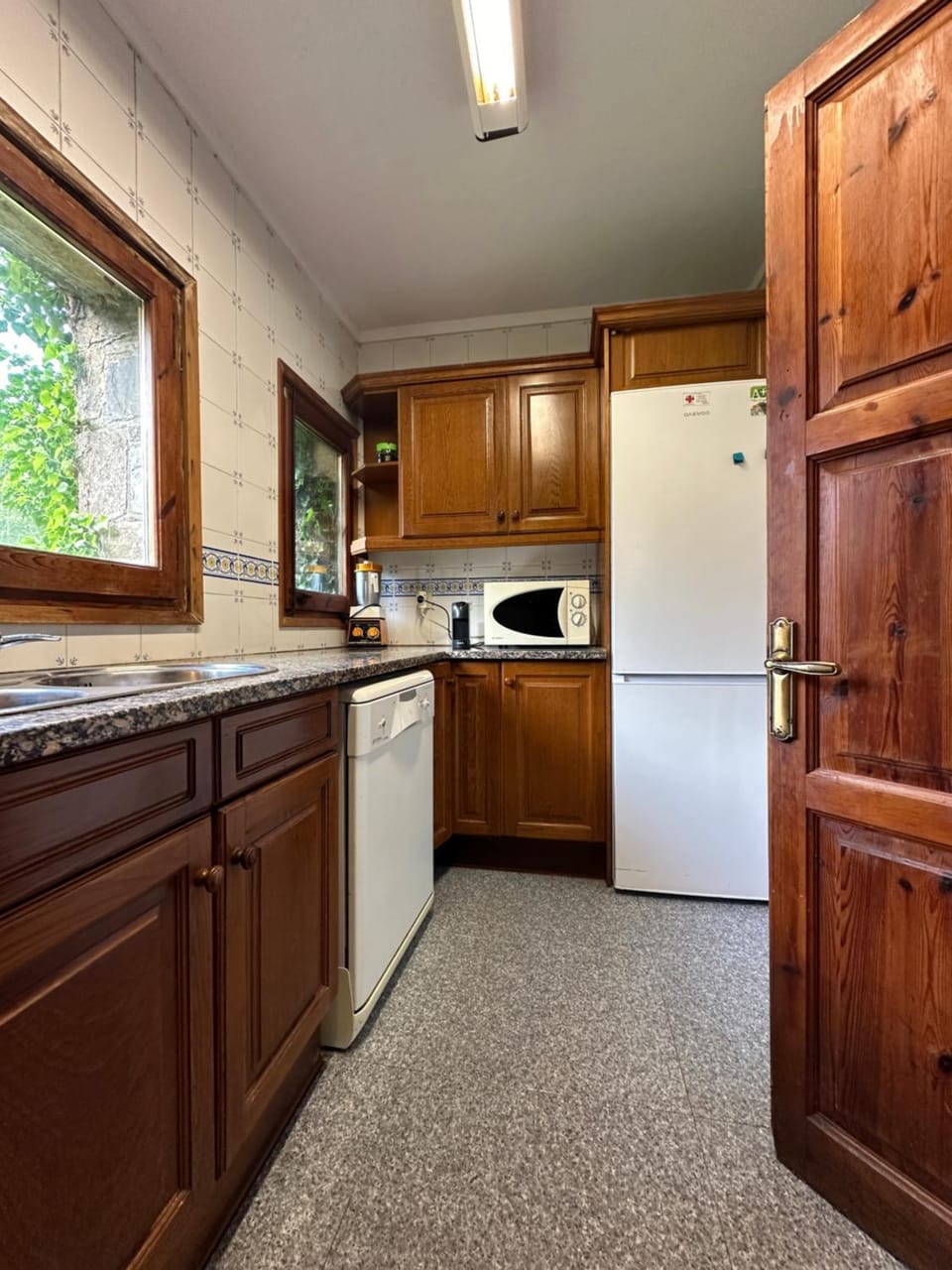 Kitchen or kitchenette, dishwasher, oven, stove