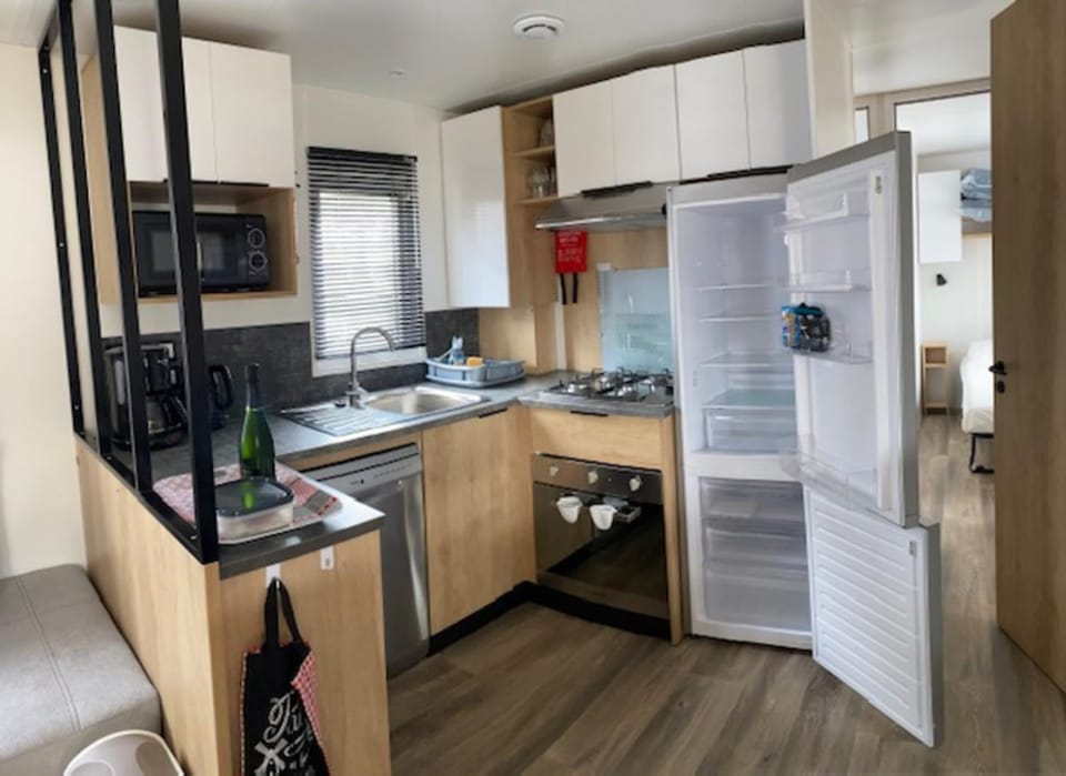 Kitchen or kitchenette, dishwasher, oven, stove
