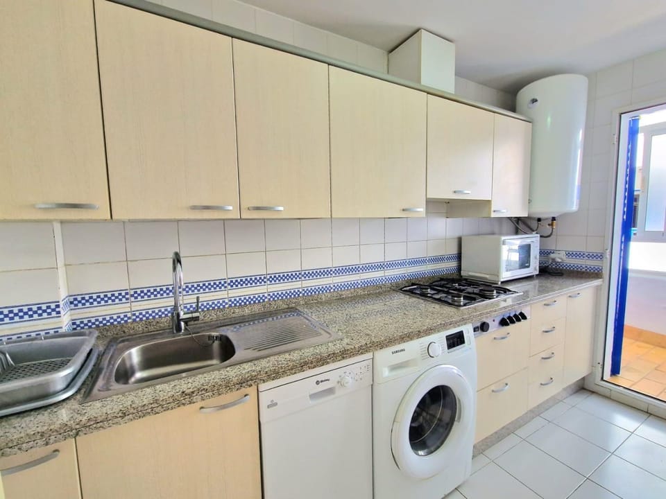 Kitchen or kitchenette, dishwasher, stove, washing machine