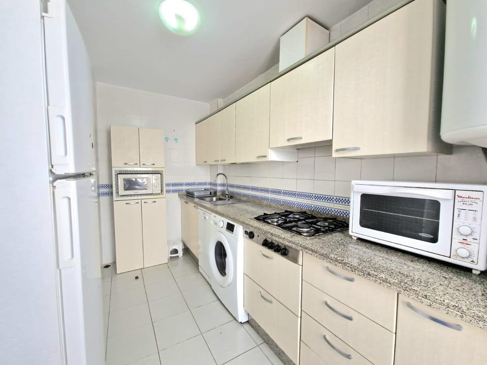 Kitchen or kitchenette, dishwasher, stove, toaster, washing machine