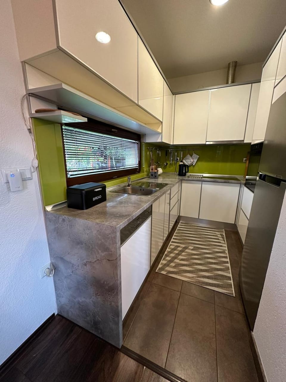 Kitchen or kitchenette, dishwasher, oven, stove