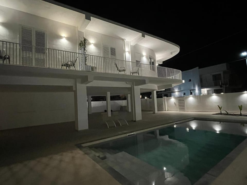 Property building, Patio, Night, Pool view, Swimming pool