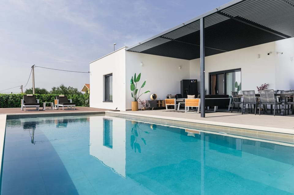 Property building, Patio, Pool view, Swimming pool, sunbed
