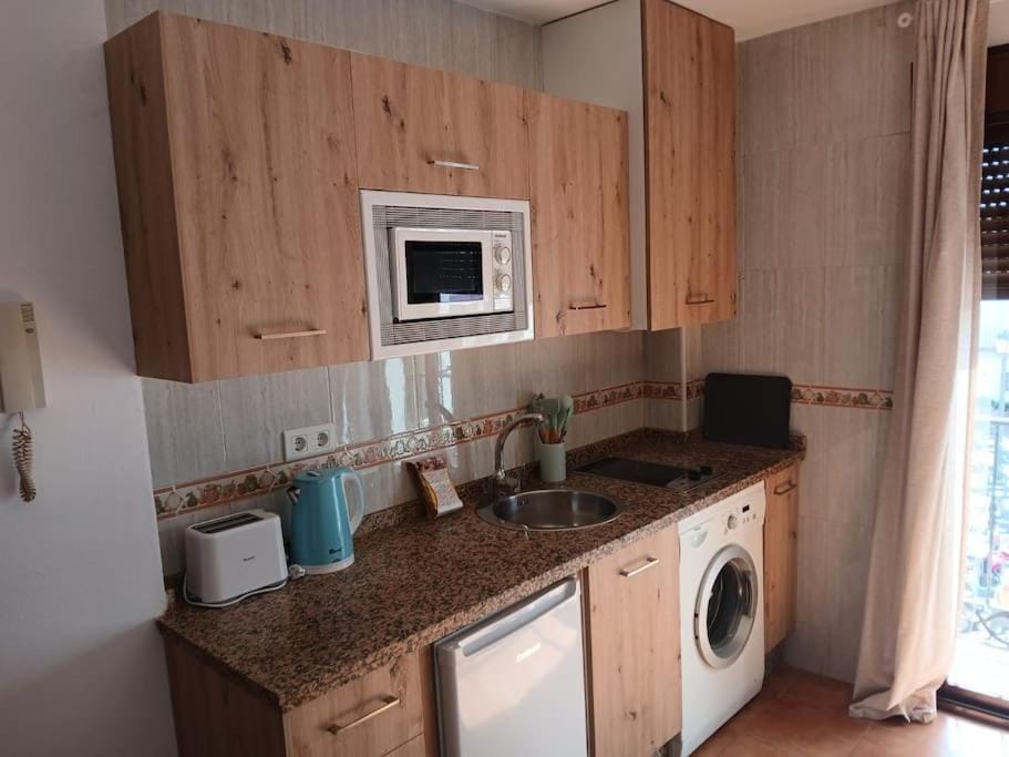 Kitchen or kitchenette, stove, toaster, washing machine