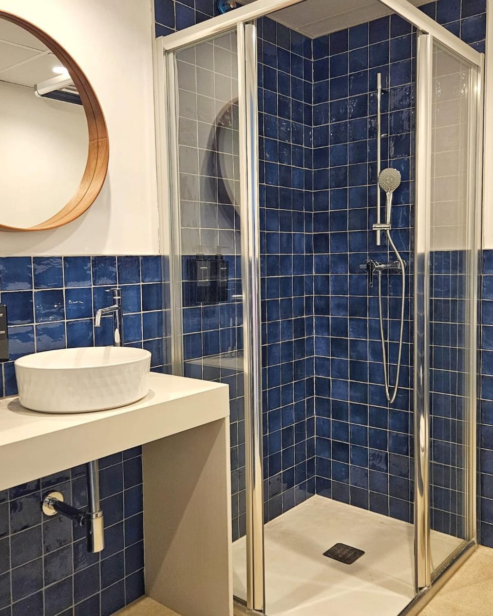 Shower, Toilet, Bathroom, hair dryier, towels, air conditioner