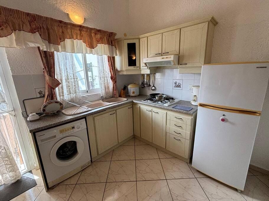 Kitchen or kitchenette, stove, toaster, washing machine