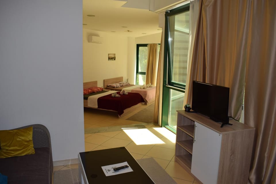 Bed, TV and multimedia, Living room, Seating area, Bedroom, air conditioner