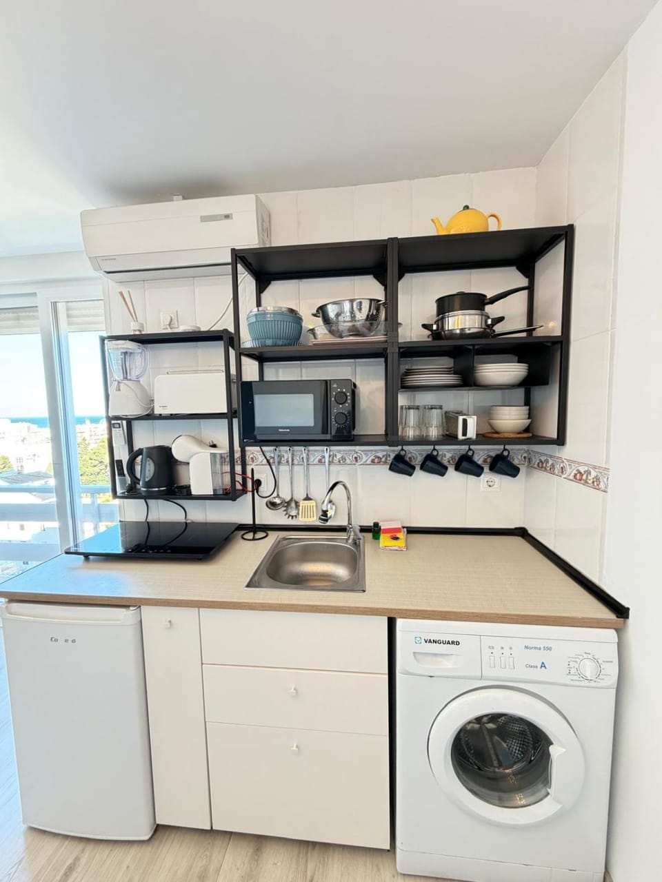Kitchen or kitchenette, stove, washing machine