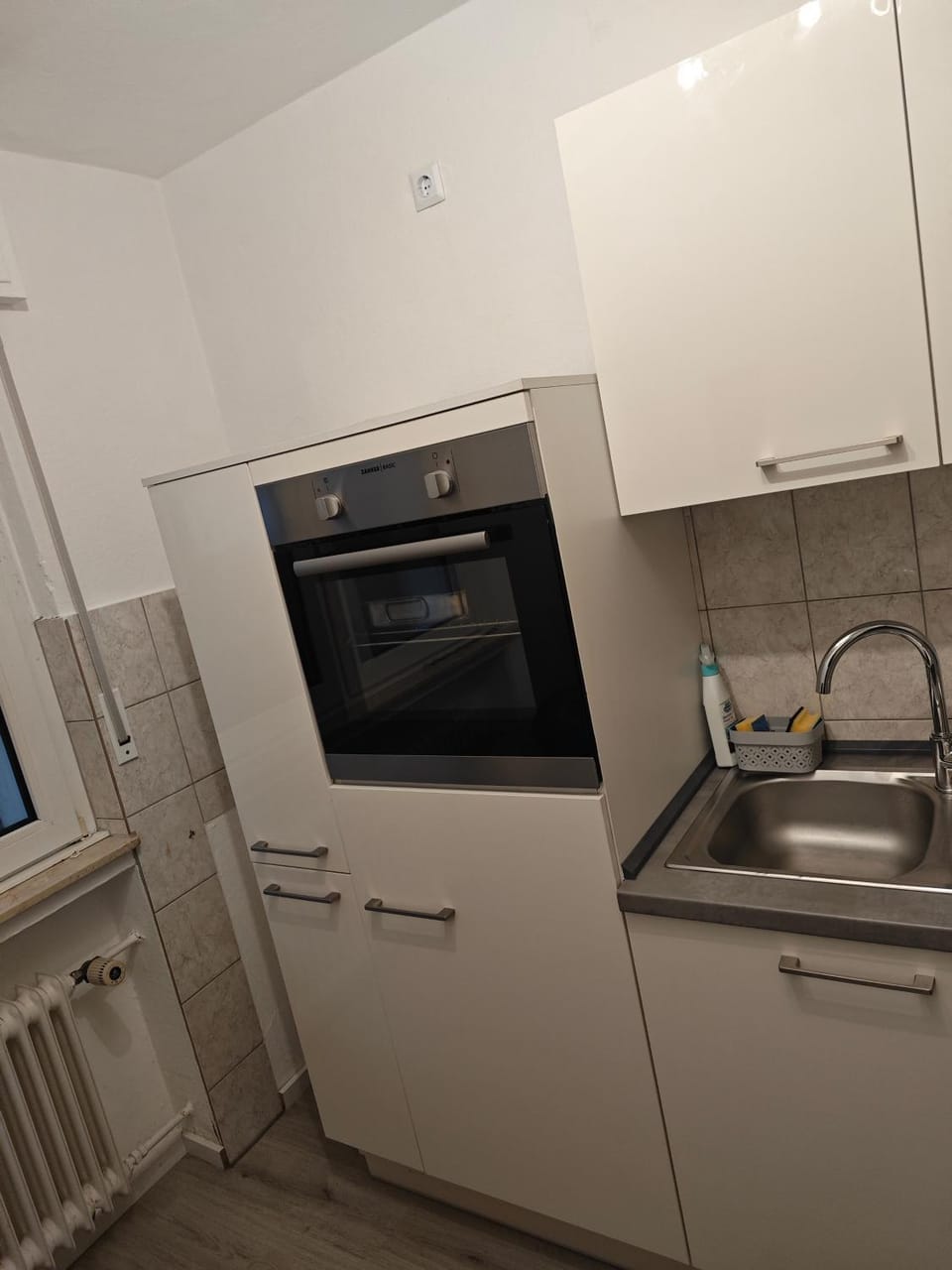 Kitchen or kitchenette, dishwasher, oven, stove