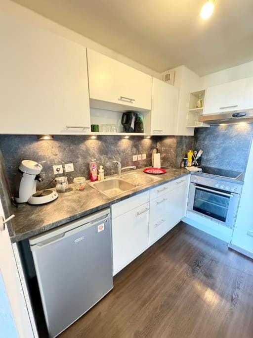 Kitchen or kitchenette, dishwasher, oven, stove