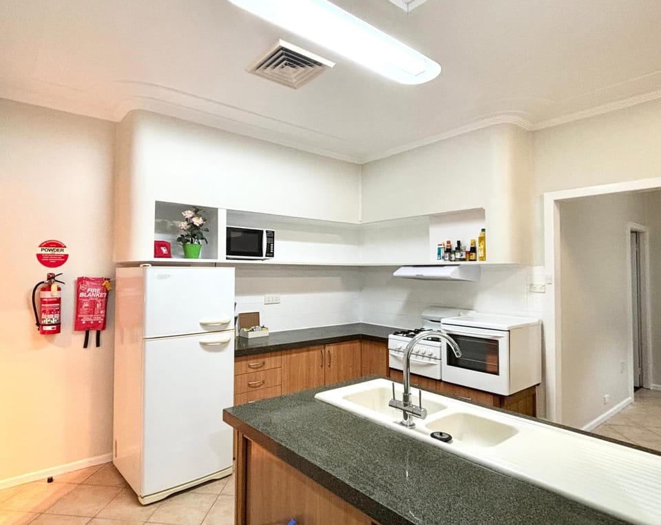 Kitchen or kitchenette, dishwasher, oven, stove